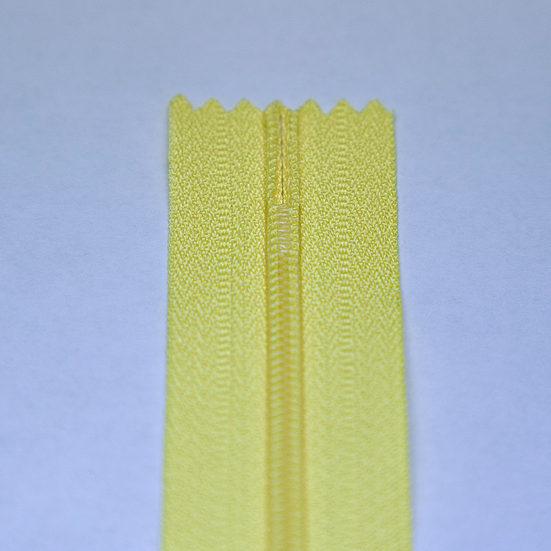 Hot-melt nylon zipper with a bottom stop